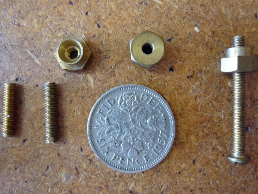 Another closeup of 6BA screws and cup nuts. Threaded 7/16" section at left is similar to what Brian used for the posts which were screwed into the body, soldered at the top end and had the pickup wires soldered to them