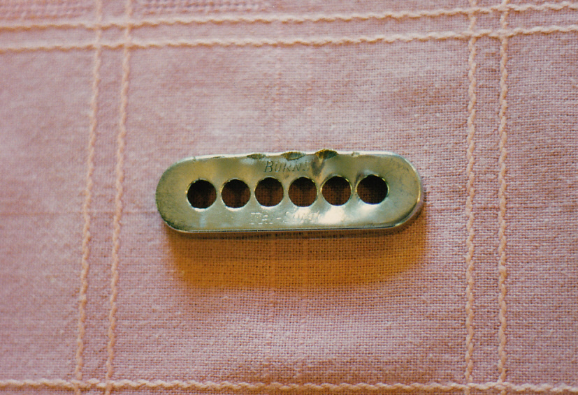 Red Special bridge pickup cover showing sixpence attack